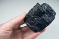 Lump of Raw Coal in Hand Royalty Free Stock Photo