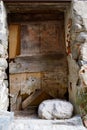 Lump of rock in front of an old morbid door Royalty Free Stock Photo