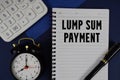 Lump Sum Payment text written on notepad with calculator and alarm clock on navy blue background Royalty Free Stock Photo