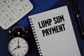 Lump Sum Payment text written on notepad with calculator and alarm clock on navy blue background Royalty Free Stock Photo