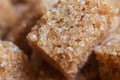 Lumps of brown pressed cane sugar. Close-up.