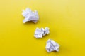 Lumps of crumpled paper on a yellow background