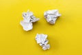 Lumps of crumpled paper on a yellow background