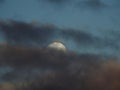 Luna de nieve detras de las nubes negras