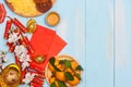 Lunar new year.Firecrackers and Chinese gold ingots and Traditional Red envelopes and decoration with Fresh oranges on wooden