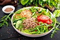 Lunch bowl with buckwheat porridge, fried chicken cutlets and fresh vegetable salad of arugula, lettuce, chard leaves, tomato Royalty Free Stock Photo