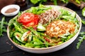 Lunch bowl with buckwheat porridge, fried chicken cutlets and fresh vegetable salad of arugula, lettuce, chard leaves, tomato Royalty Free Stock Photo