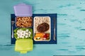 Lunch box with appetizing food and on light wooden table Royalty Free Stock Photo