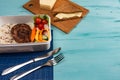 Lunch box with appetizing food and on light wooden table Royalty Free Stock Photo