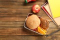 Lunch box with appetizing food and notebooks Royalty Free Stock Photo