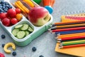 Lunch box with appetizing food and stationery on grey table Royalty Free Stock Photo