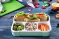 Lunch box with appetizing food on wooden table Royalty Free Stock Photo