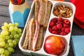 Lunch box with appetizing food on wooden table Royalty Free Stock Photo