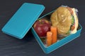 Lunch box , cheese sandwich, apple and carrots