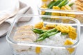 Lunch box containers with grilled chicken, rice and green beans with corn Royalty Free Stock Photo