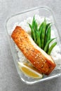 Lunch box containers with grilled salmon fish fillet, rice and green beans Royalty Free Stock Photo