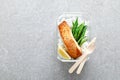 Lunch box containers with grilled salmon fish fillet, rice and green beans Royalty Free Stock Photo