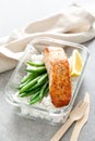 Lunch box containers with grilled salmon fish fillet, rice and green beans Royalty Free Stock Photo
