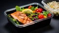 Lunch box containers with grilled salmon fish fillet, rice and salad Royalty Free Stock Photo