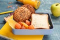 Lunch box with delicious food and stationery on table Royalty Free Stock Photo