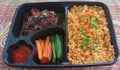 Lunch box with kebuli rice and chicken steak Royalty Free Stock Photo