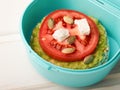 Lunch box with a rice cake sandwich and avocado with tomato and feta cheese with pumpkin seeds Royalty Free Stock Photo