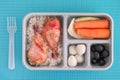 Lunch box with rice and chicken, quail eggs, black olives and vegetables