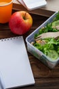 Lunch box with salad, apple, tangerine and juice. Royalty Free Stock Photo