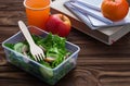 Lunch box with salad, apple, tangerine and juice. Royalty Free Stock Photo