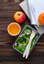 Lunch box with salad, apple, tangerine and juice. Royalty Free Stock Photo