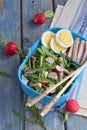 Lunch Box with salad of fresh vegetables - arugula, radish, feta cheese, ham, egg and sesame with flat bread tortilla. Healthy foo Royalty Free Stock Photo