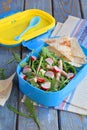 Lunch Box with salad of fresh vegetables - arugula, radish, feta cheese, ham and sesame with flat bread tortilla. Healthy food. Lu Royalty Free Stock Photo