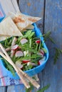 Lunch Box with salad of fresh vegetables - arugula, radish, feta cheese, ham and sesame with flat bread tortilla. Healthy food. Lu Royalty Free Stock Photo