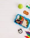 Lunch box with sandwich, vegetables, berries on white wooden background with clock, watercolor and pencils