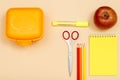 Lunch box, scissors, color pencils, felt pen, apple and notebook Royalty Free Stock Photo