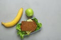 Lunch box with tasty sandwich and fruits Royalty Free Stock Photo