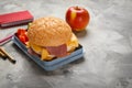 Lunch box with tasty sandwich and stationery Royalty Free Stock Photo