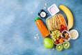 Lunch box with vegetables, fruits and sandwich for healthy snack on table top view. Back to school concept. Royalty Free Stock Photo