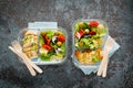 Lunch boxes with grilled chicken breast and pasta salad with fresh vegetables. Top view Royalty Free Stock Photo