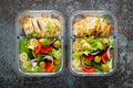 Lunch boxes with grilled chicken breast and pasta salad with fresh vegetables, top view Royalty Free Stock Photo