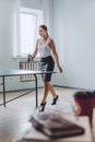 Lunch break activities concept. Office games during Lunch break. Attractive young Business woman playing ping pong, table tennis Royalty Free Stock Photo