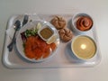 Lunch break at ikea shop, eating healthy and delicious food, salmon, sauce, vegetable soup, bread and cinnamon roll Royalty Free Stock Photo