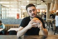 Lunch at the cafe. Greedy looks at the burger