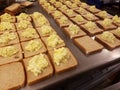 Dozens of egg salad sandwiches on metal table at the soup kitchen, feeding the hungry