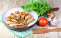 Lunch fried chicken legs and vegetables on wooden table