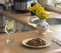 lunch at home in the kitchen, buckwheat vegetables and turkey with a glass of water and lemon