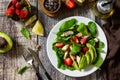 Lunch for keto. Summer salad with strawberries, grilled chicken and avocado on a rustic table. Royalty Free Stock Photo