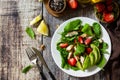 Lunch for keto. Summer salad with strawberries, grilled chicken and avocado on a rustic table. Royalty Free Stock Photo