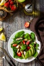 Lunch for keto. Summer salad with strawberries, grilled chicken and avocado on a rustic table Royalty Free Stock Photo