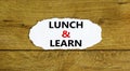 Lunch and learn symbol. Words `Lunch and learn` on white paper. Beautiful wooden background. Business, educational and lunch and